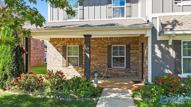 view of exterior entry featuring covered porch