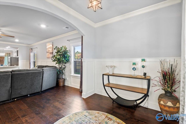 foyer entrance with ornamental molding, ceiling fan, and dark hardwood / wood-style floors