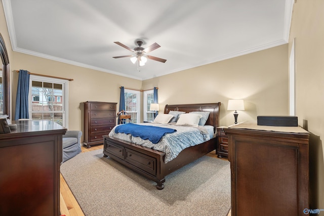 bedroom with ceiling fan, light hardwood / wood-style floors, and ornamental molding