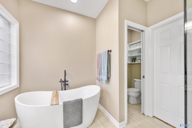 bathroom with a bathing tub and toilet