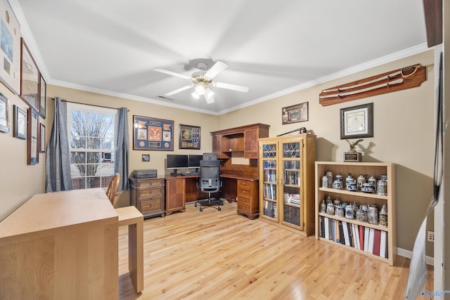 home office featuring ceiling fan, crown molding, and light hardwood / wood-style floors