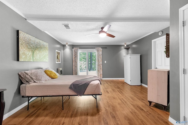 bedroom featuring light wood-type flooring and a textured ceiling