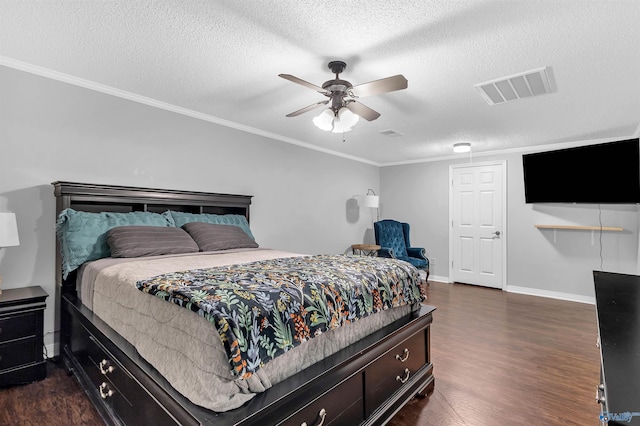 bedroom featuring a textured ceiling, visible vents, baseboards, ornamental molding, and dark wood-type flooring