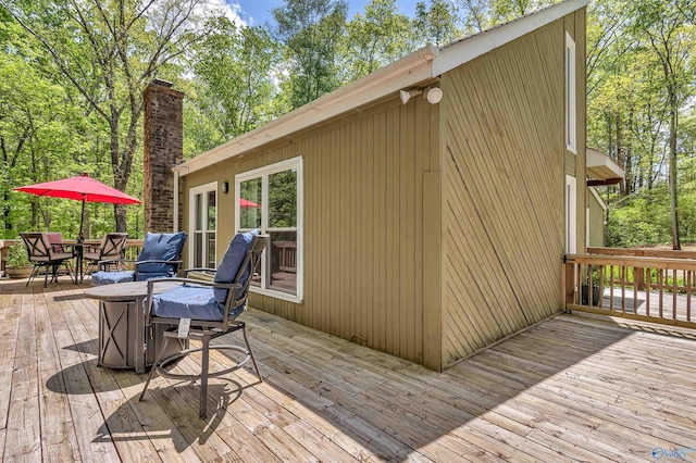 wooden deck featuring outdoor dining area
