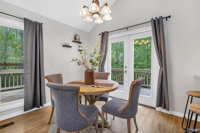 dining room with a notable chandelier, visible vents, a healthy amount of sunlight, and light wood-style floors
