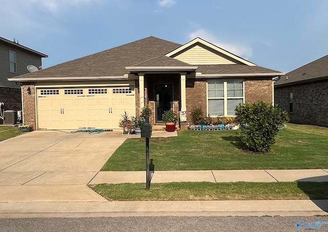 view of front of property with central AC unit, a garage, and a front lawn