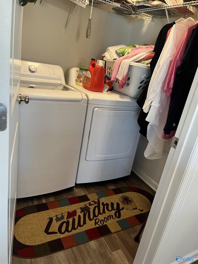 laundry area featuring dark hardwood / wood-style flooring and washing machine and clothes dryer