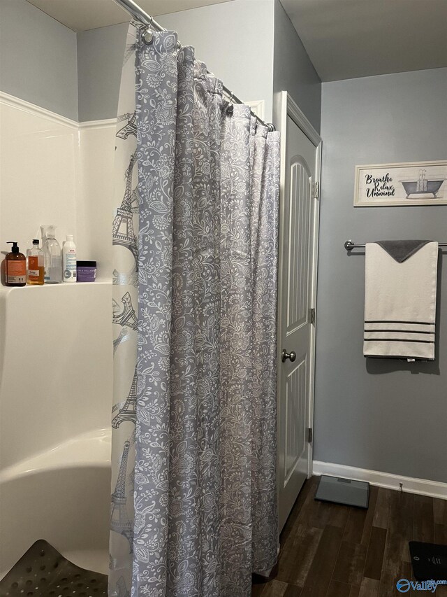 bathroom with hardwood / wood-style floors