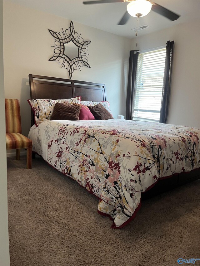 bedroom featuring ceiling fan and carpet