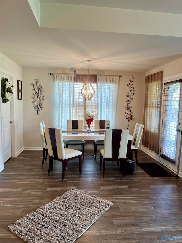 dining area featuring a notable chandelier and dark hardwood / wood-style floors