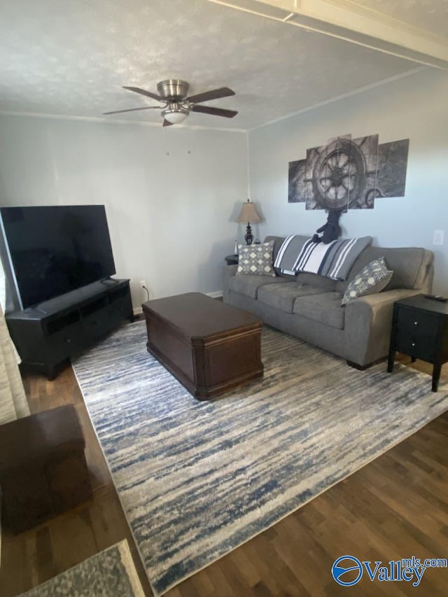 living room with a textured ceiling, ceiling fan, and hardwood / wood-style flooring