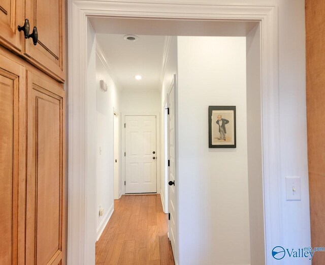 hallway with light wood-style floors and baseboards