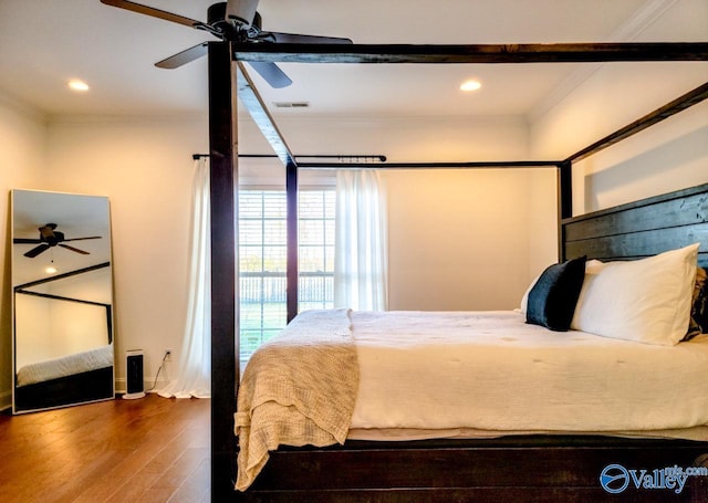 bedroom with ornamental molding, recessed lighting, visible vents, and wood finished floors