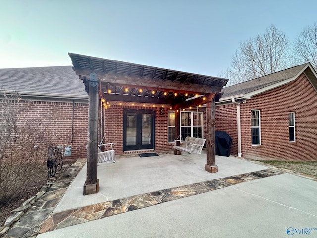 rear view of house featuring a patio and french doors