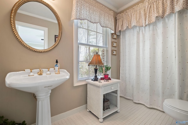 bathroom featuring crown molding, toilet, baseboards, and tile patterned floors