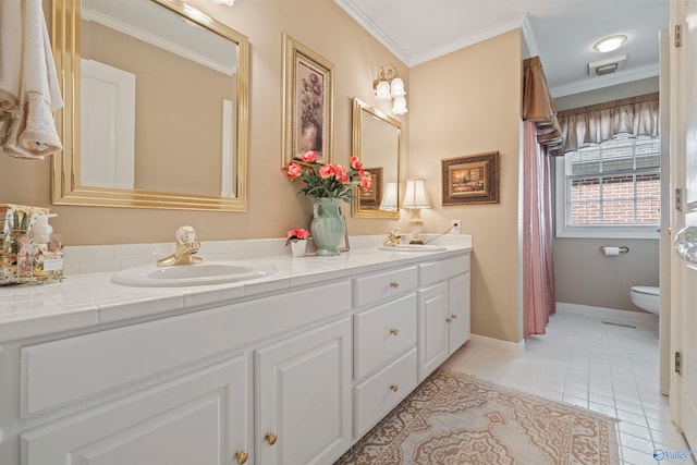 bathroom featuring double vanity, tile patterned flooring, toilet, and a sink