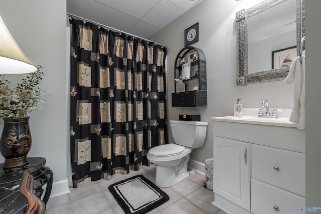 bathroom with vanity, baseboards, tile patterned flooring, curtained shower, and toilet