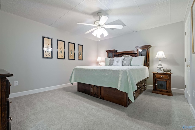 bedroom with ceiling fan, baseboards, and carpet floors