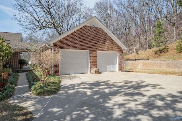 exterior space with brick siding and concrete driveway