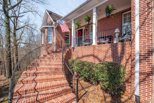 doorway to property with brick siding