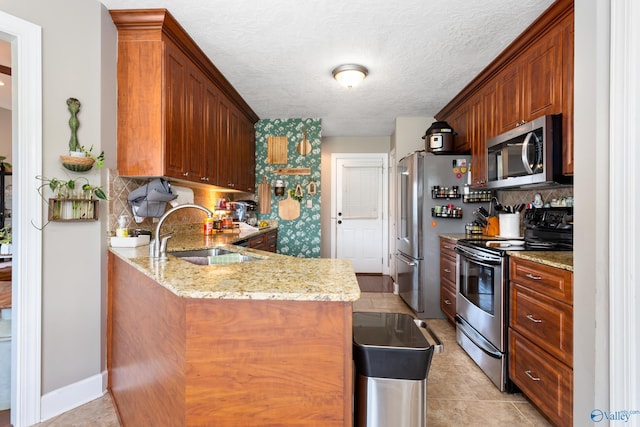 1465 Marshall Way, Southside, AL 35907 - kitchen with appliances with stainless steel finishes, a sink, tasteful backsplash, a peninsula, and a textured ceiling