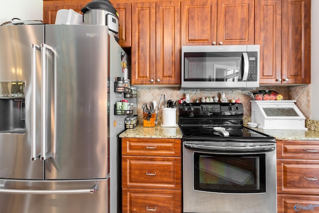 1465 Marshall Way, Southside, AL 35907 - kitchen featuring appliances with stainless steel finishes, backsplash, and light stone countertops