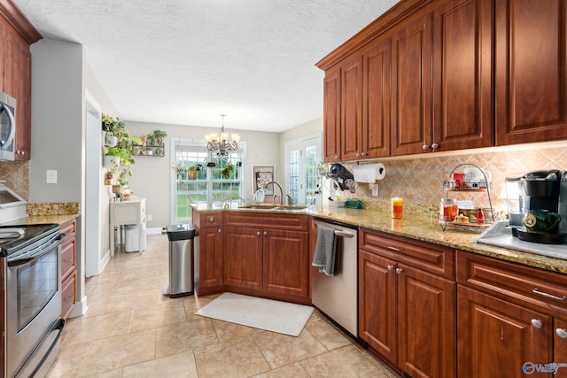 1465 Marshall Way, Southside, AL 35907 - kitchen featuring stainless steel appliances, a sink, tasteful backsplash, a peninsula, and a chandelier