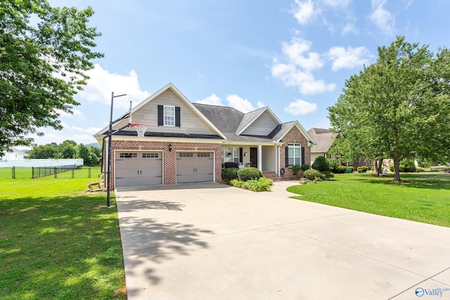 1465 Marshall Way, Southside, AL 35907 - view of front facade featuring brick siding, concrete driveway, covered porch, and an attached garage