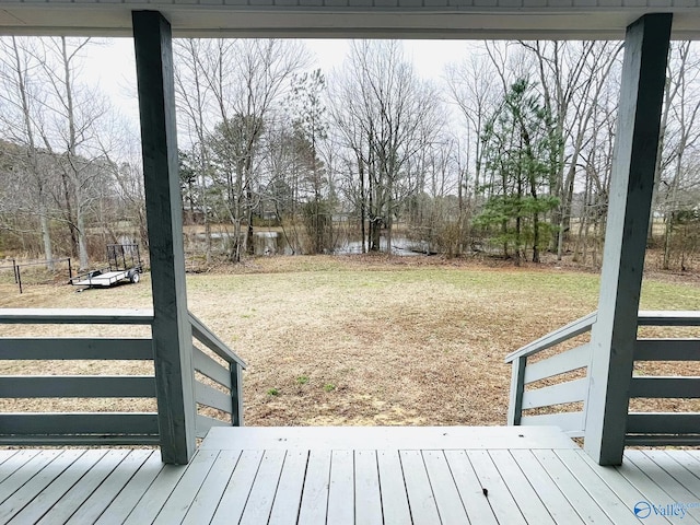 wooden deck featuring a lawn