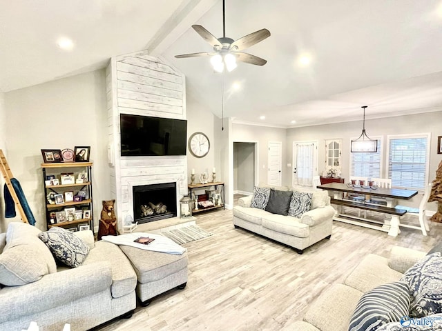 living room with vaulted ceiling with beams, light hardwood / wood-style flooring, a fireplace, and ceiling fan