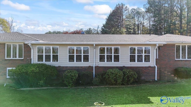 view of side of property with a lawn