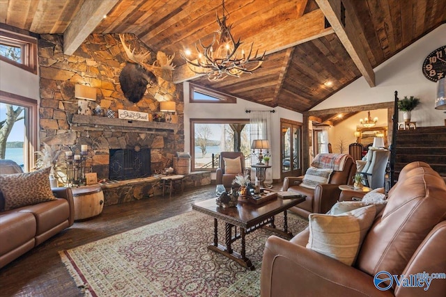 living room featuring wood ceiling, wood finished floors, a water view, an inviting chandelier, and a stone fireplace