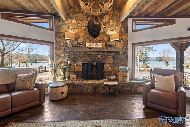 living area with dark wood-style flooring, a fireplace, a water view, wood ceiling, and beamed ceiling