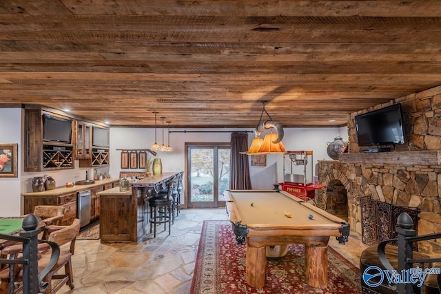 game room with billiards, wood ceiling, bar, stone tile flooring, and a fireplace