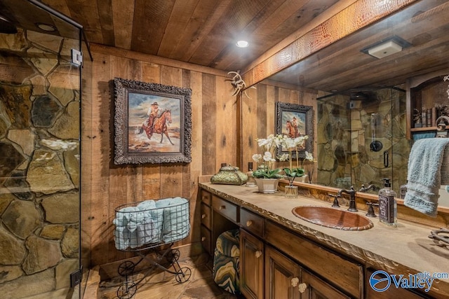 full bathroom featuring wooden walls, wooden ceiling, a shower stall, and vanity