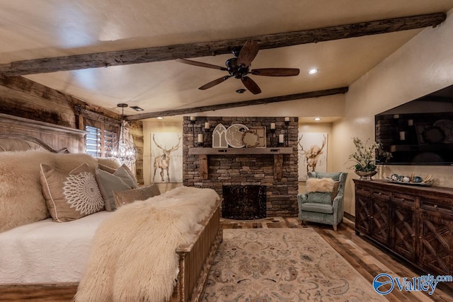 bedroom featuring vaulted ceiling with beams, a fireplace, and wood finished floors