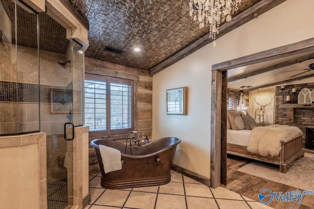 full bathroom featuring a stall shower, a soaking tub, wood finished floors, and an ornate ceiling