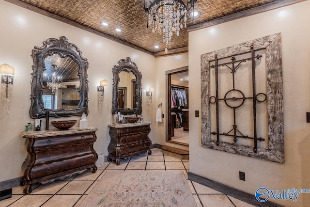 corridor with recessed lighting, crown molding, baseboards, an ornate ceiling, and an inviting chandelier