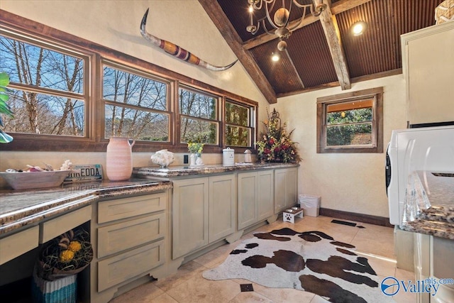 kitchen with vaulted ceiling with beams, light tile patterned floors, wood ceiling, and baseboards