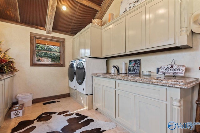 washroom featuring light tile patterned floors, wooden ceiling, washing machine and dryer, baseboards, and cabinet space