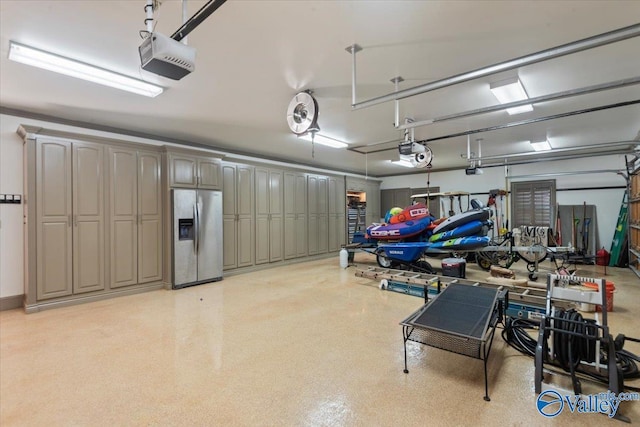 garage featuring stainless steel fridge and a garage door opener