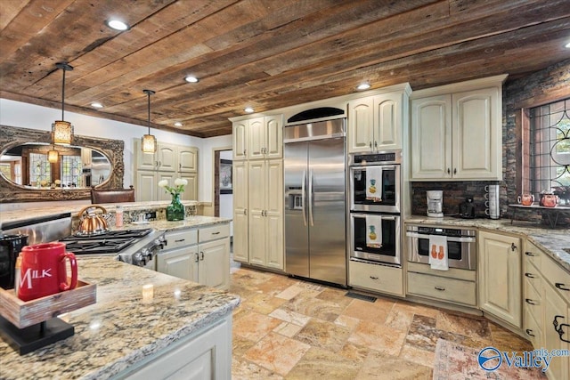 kitchen featuring wood ceiling, hanging light fixtures, cream cabinetry, appliances with stainless steel finishes, and light stone countertops