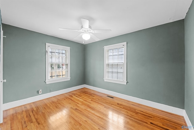 spare room with hardwood / wood-style flooring and ceiling fan