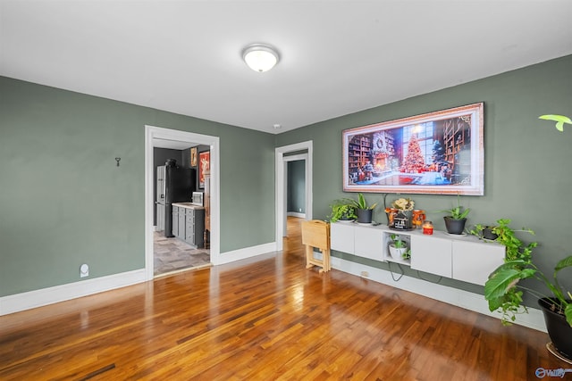 unfurnished living room with wood-type flooring