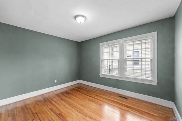 spare room with light hardwood / wood-style floors