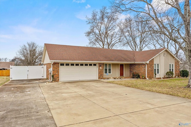 ranch-style house with a garage and a front lawn