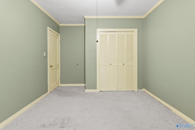 unfurnished bedroom with crown molding, light carpet, and a closet