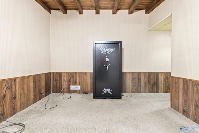 interior space featuring wood walls, beamed ceiling, and wood ceiling