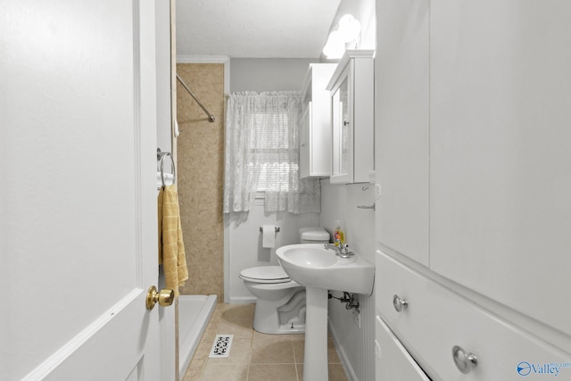 bathroom featuring toilet and tile patterned floors