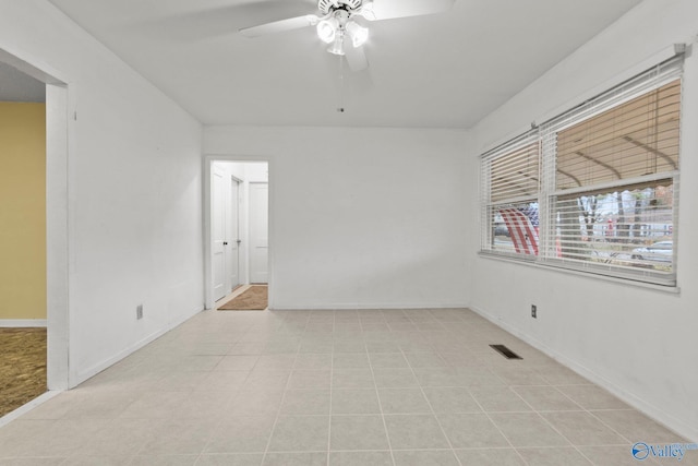 spare room with light tile patterned floors and ceiling fan